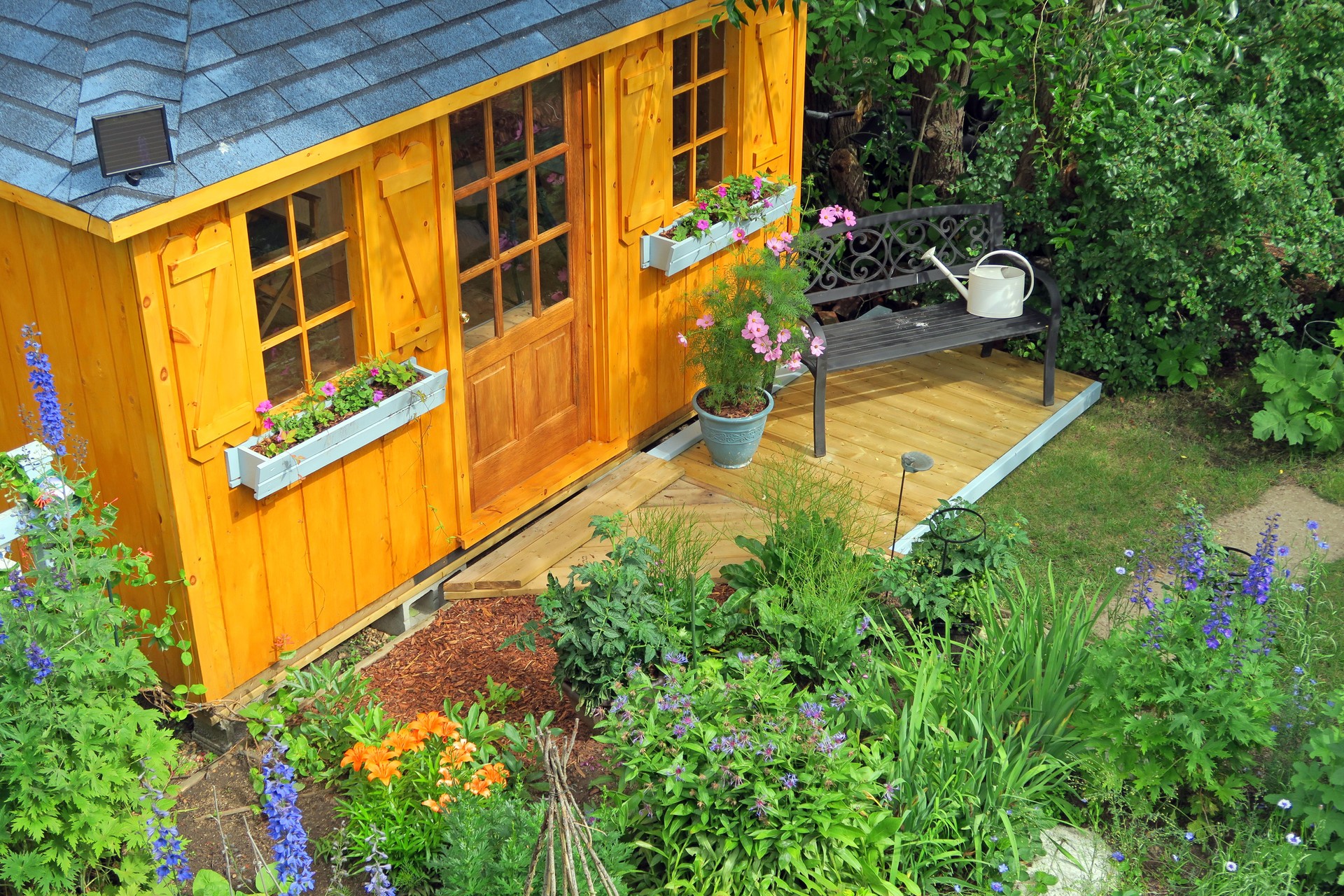 Garden shed in a flower garden with roses- from above